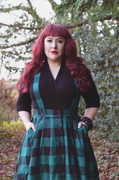 Plus size pinup Miss Amy May models the Green Teen Spirit Pinafore skirt gifted by Hell Bunny for a fit and sizing review
