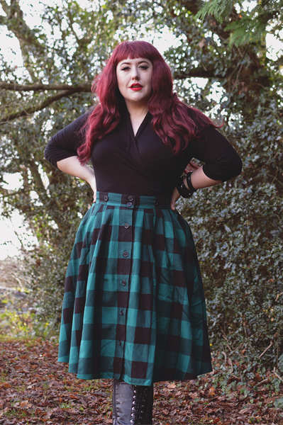 Plus size pinup Miss Amy May models the Green Teen Spirit Pinafore skirt gifted by Hell Bunny for a fit and sizing review