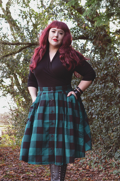 Plus size pinup Miss Amy May models the Green Teen Spirit Pinafore skirt gifted by Hell Bunny for a fit and sizing review