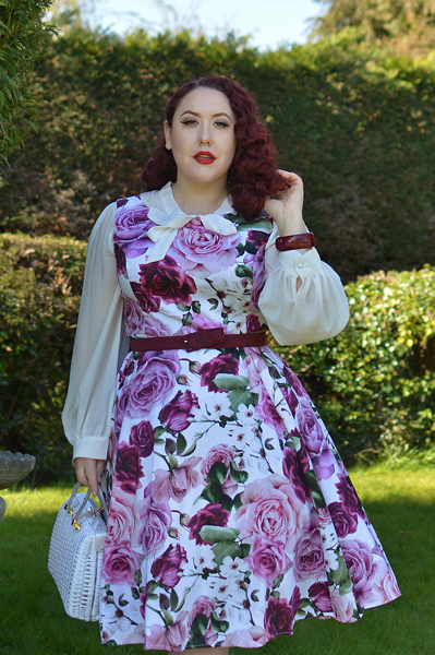 Plus size pinup Miss Amy May models the Alice Floral Swing dress gifted by Hearts and Roses London for a fit and size review