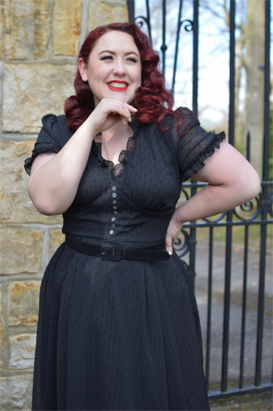 Plus size pinup Miss Amy May models the black Frilly Sundae dress gifted by Hell Bunny for a fit and size review