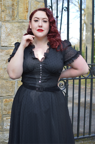 Plus size pinup Miss Amy May models the black Frilly Sundae dress gifted by Hell Bunny for a fit and size review