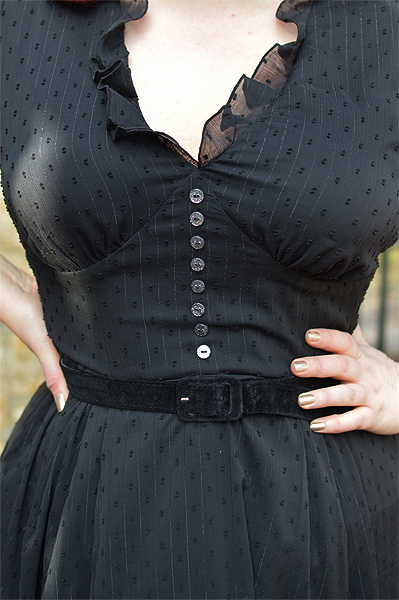 Plus size pinup Miss Amy May models the black Frilly Sundae dress gifted by Hell Bunny for a fit and size review