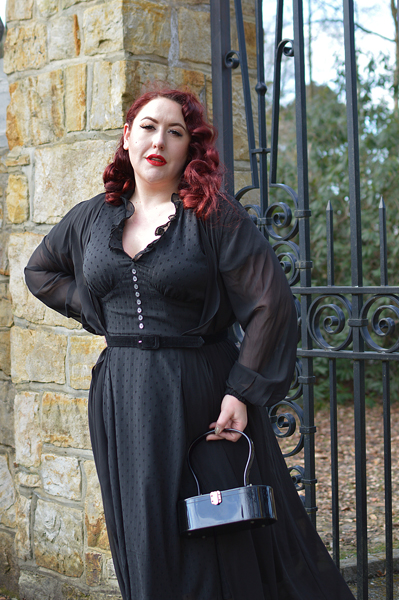 Plus size pinup Miss Amy May models the black Frilly Sundae dress gifted by Hell Bunny for a fit and size review