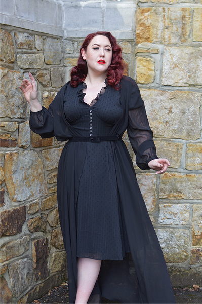 Plus size pinup Miss Amy May models the black Frilly Sundae dress gifted by Hell Bunny for a fit and size review