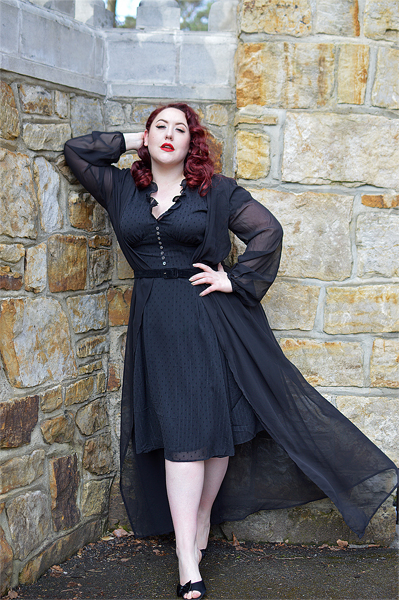 Plus size pinup Miss Amy May models the black Frilly Sundae dress gifted by Hell Bunny for a fit and size review