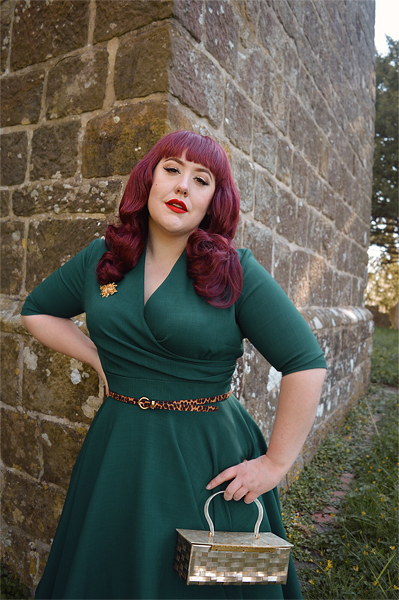 Plus size pinup Miss Amy May modelling the forest green Leyla midi swing dress by The Pretty Dress company for a fit and sizing review