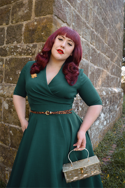 Plus size pinup Miss Amy May modelling the forest green Leyla midi swing dress by The Pretty Dress company for a fit and sizing review