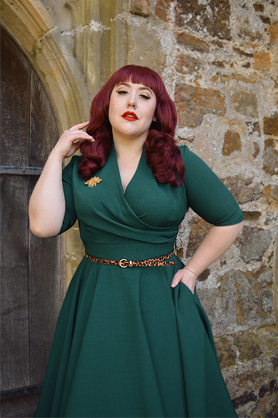 Plus size pinup Miss Amy May modelling the forest green Leyla midi swing dress by The Pretty Dress company for a fit and sizing review