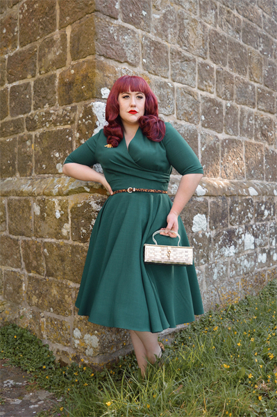 Plus size pinup Miss Amy May modelling the forest green Leyla midi swing dress by The Pretty Dress company for a fit and sizing review