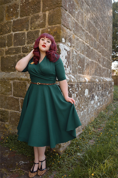 Plus size pinup Miss Amy May modelling the forest green Leyla midi swing dress by The Pretty Dress company for a fit and sizing review