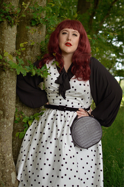 Plus size pinup Miss Amy May models the Polka Dot May crossover bust swing dress gifted by Dolly & Dotty for a fit and size review