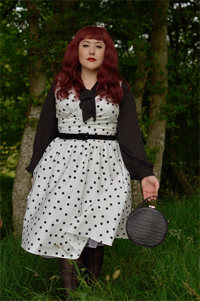 Plus size pinup Miss Amy May models the Polka Dot May crossover bust swing dress gifted by Dolly & Dotty for a fit and size review