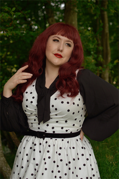 Plus size pinup Miss Amy May models the Polka Dot May crossover bust swing dress gifted by Dolly & Dotty for a fit and size review