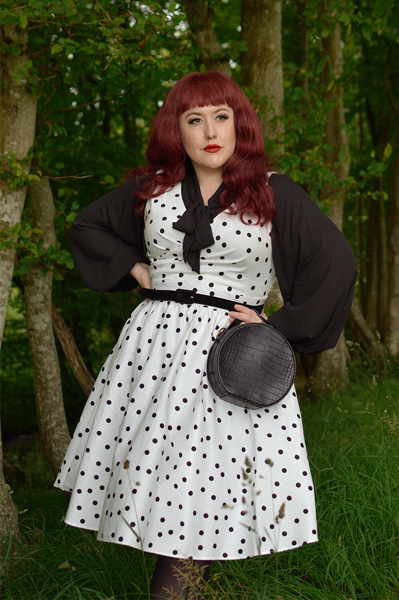 Plus size pinup Miss Amy May models the Polka Dot May crossover bust swing dress gifted by Dolly & Dotty for a fit and size review