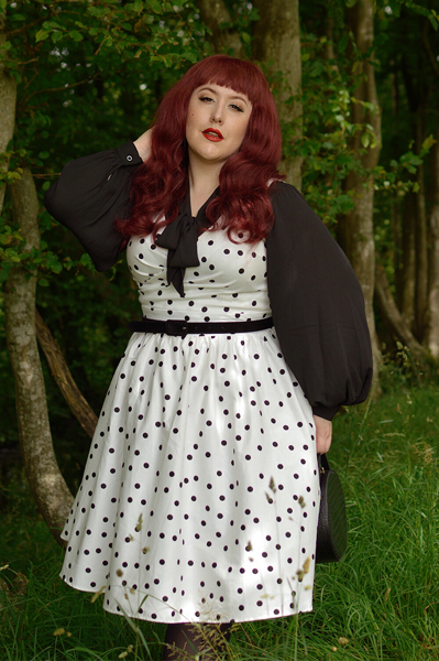 Plus size pinup Miss Amy May models the Polka Dot May crossover bust swing dress gifted by Dolly & Dotty for a fit and size review
