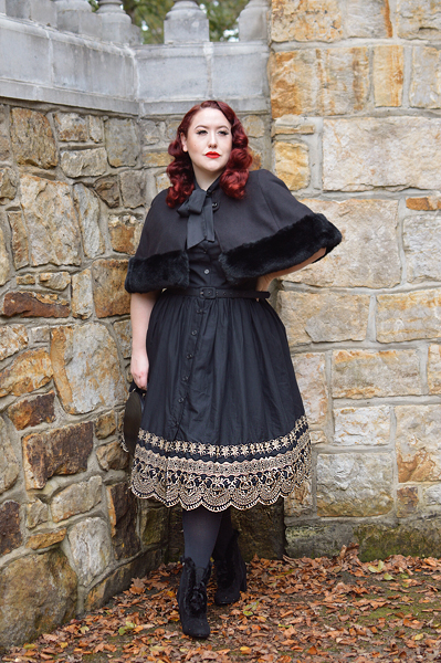 Plus size pinup Miss Amy May models the Black and Gold Eyelet Border Cora dress by Unique Vintage for a fit and sizing review