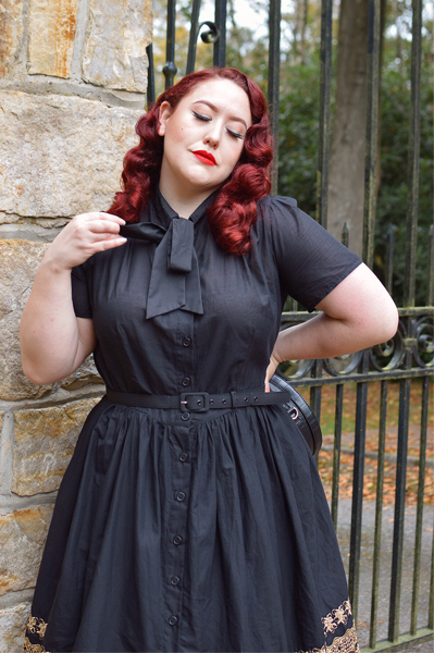 Plus size pinup Miss Amy May models the Black and Gold Eyelet Border Cora dress by Unique Vintage for a fit and sizing review
