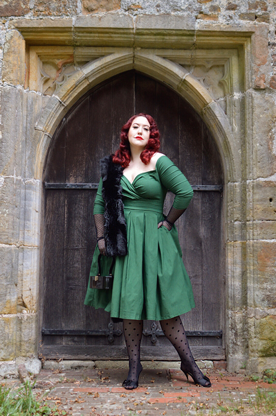 Plus size pinup Miss Amy May models the green Marceline dress by Unique Vintage for a fit and sizing review