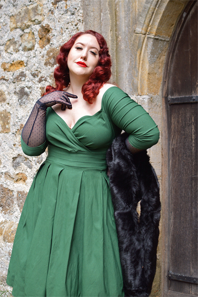Plus size pinup Miss Amy May models the green Marceline dress by Unique Vintage for a fit and sizing review
