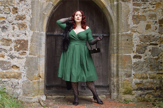 Plus size pinup Miss Amy May models the green Marceline dress by Unique Vintage for a fit and sizing review