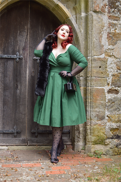 Plus size pinup Miss Amy May models the green Marceline dress by Unique Vintage for a fit and sizing review