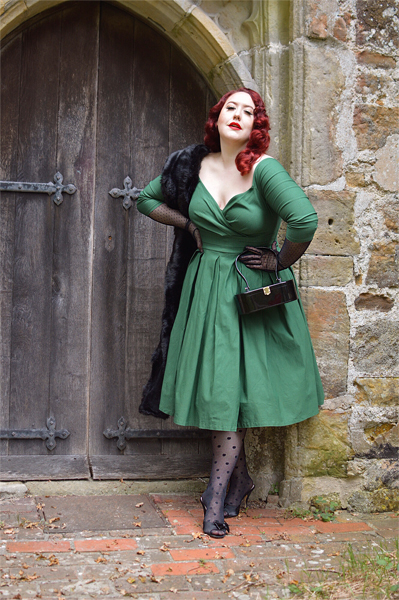 Plus size pinup Miss Amy May models the green Marceline dress by Unique Vintage for a fit and sizing review