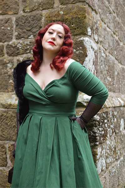 Plus size pinup Miss Amy May models the green Marceline dress by Unique Vintage for a fit and sizing review