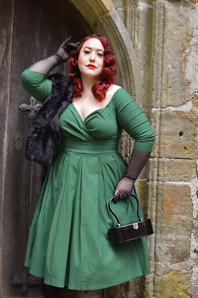 Plus size pinup Miss Amy May models the green Marceline dress by Unique Vintage for a fit and sizing review