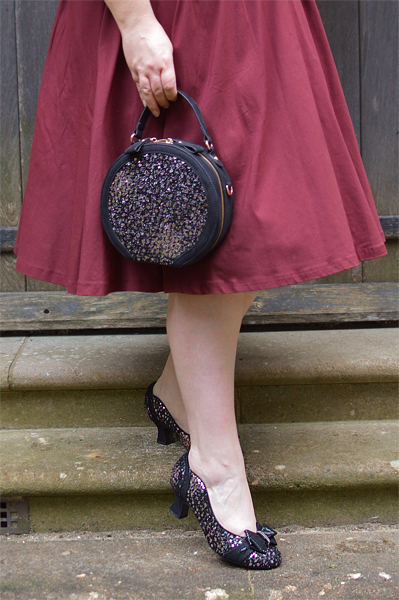 Pinup Miss Amy May models the black sequin Rhea low court heels and black sequin Alberta bag by Ruby Shoo for review