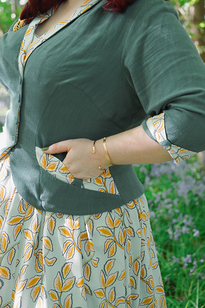 Plus size pinup Miss Amy May models the Kimmie-gia dress and Samira-Gia jacket by Miss Candyfloss for a fit and size freview