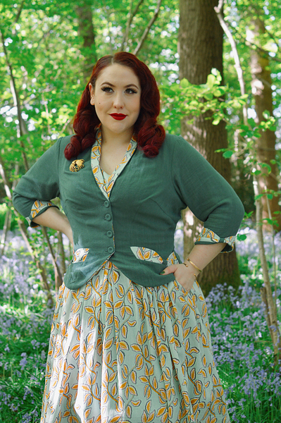 Plus size pinup Miss Amy May models the Kimmie-gia dress and Samira-Gia jacket by Miss Candyfloss for a fit and size freview