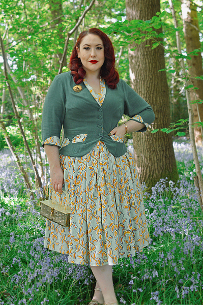 Plus size pinup Miss Amy May models the Kimmie-gia dress and Samira-Gia jacket by Miss Candyfloss for a fit and size freview