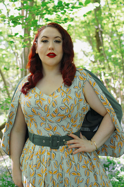Plus size pinup Miss Amy May models the Kimmie-gia dress and Samira-Gia jacket by Miss Candyfloss for a fit and size freview