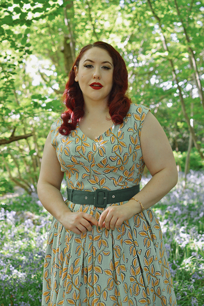 Plus size pinup Miss Amy May models the Kimmie-gia dress and Samira-Gia jacket by Miss Candyfloss for a fit and size freview