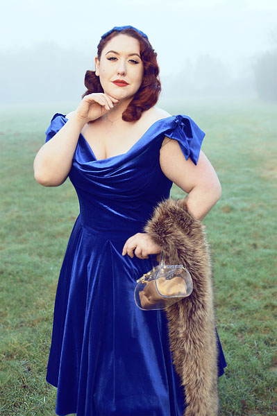 Plus size pinup Miss Amy May models the Sapphire Velvet Tilly Bow Prom swing dress by The Pretty Dress Company for a fit and size review