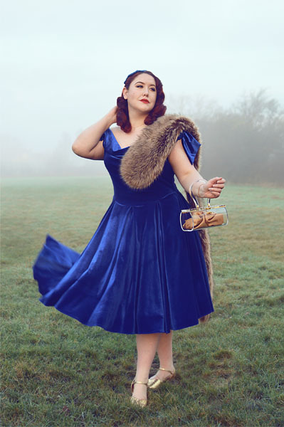 Plus size pinup Miss Amy May models the Sapphire Velvet Tilly Bow Prom swing dress by The Pretty Dress Company for a fit and size review