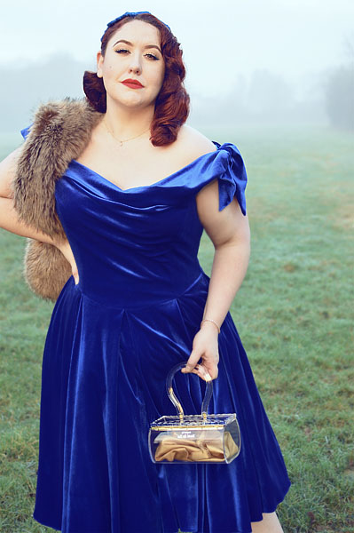 Plus size pinup Miss Amy May models the Sapphire Velvet Tilly Bow Prom swing dress by The Pretty Dress Company for a fit and size review