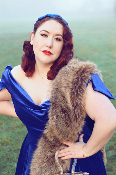 Plus size pinup Miss Amy May models the Sapphire Velvet Tilly Bow Prom swing dress by The Pretty Dress Company for a fit and size review
