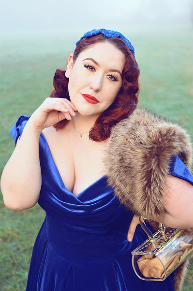 Plus size pinup Miss Amy May models the Sapphire Velvet Tilly Bow Prom swing dress by The Pretty Dress Company for a fit and size review