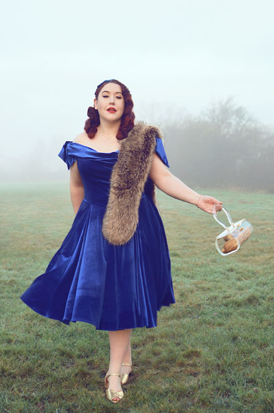 Plus size pinup Miss Amy May models the Sapphire Velvet Tilly Bow Prom swing dress by The Pretty Dress Company for a fit and size review