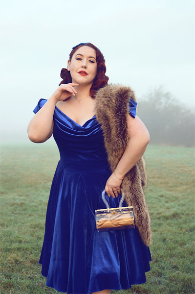 Plus size pinup Miss Amy May models the Sapphire Velvet Tilly Bow Prom swing dress by The Pretty Dress Company for a fit and size review