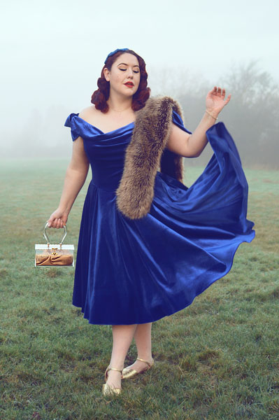 Plus size pinup Miss Amy May models the Sapphire Velvet Tilly Bow Prom swing dress by The Pretty Dress Company for a fit and size review