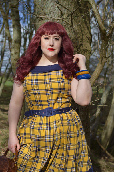 Plus size pinup Miss Amy May models the yellow and navy tartan Cindy circle skirt dress gifted by Dolly & Dotty for a fit and sizing review