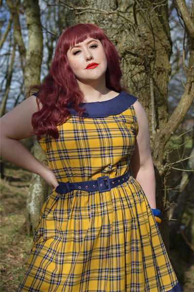 Plus size pinup Miss Amy May models the yellow and navy tartan Cindy circle skirt dress gifted by Dolly & Dotty for a fit and sizing review