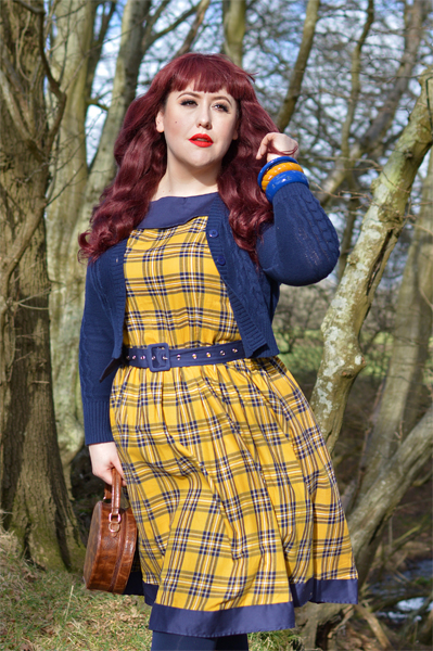 Plus size pinup Miss Amy May models the yellow and navy tartan Cindy circle skirt dress gifted by Dolly & Dotty for a fit and sizing review