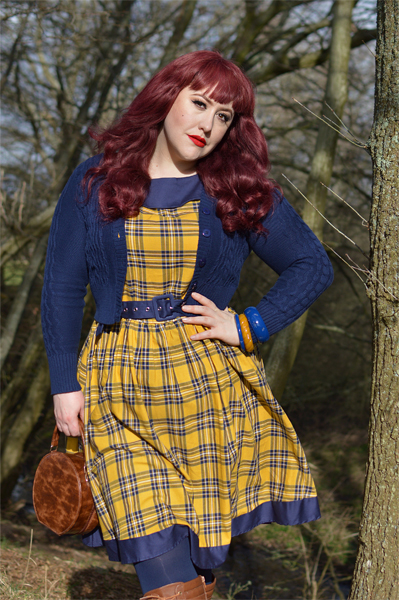 Plus size pinup Miss Amy May models the yellow and navy tartan Cindy circle skirt dress gifted by Dolly & Dotty for a fit and sizing review