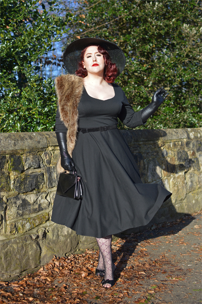 Plus size pinup Miss Amy May models the black Scarlette dress by Dolly & Dotty for a fit and sizing review