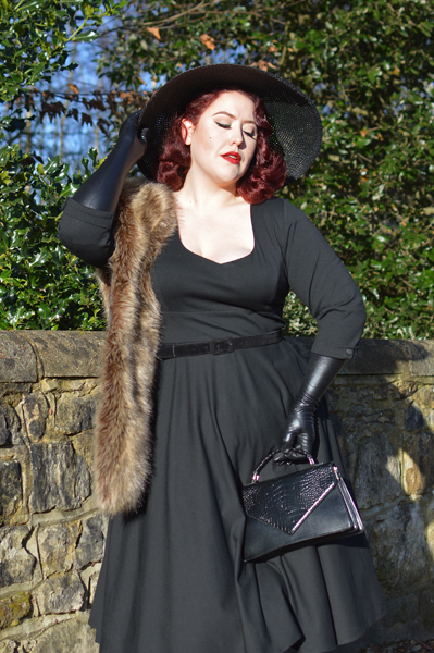 Plus size pinup Miss Amy May models the black Scarlette dress by Dolly & Dotty for a fit and sizing review