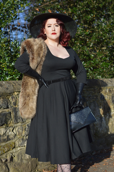 Plus size pinup Miss Amy May models the black Scarlette dress by Dolly & Dotty for a fit and sizing review